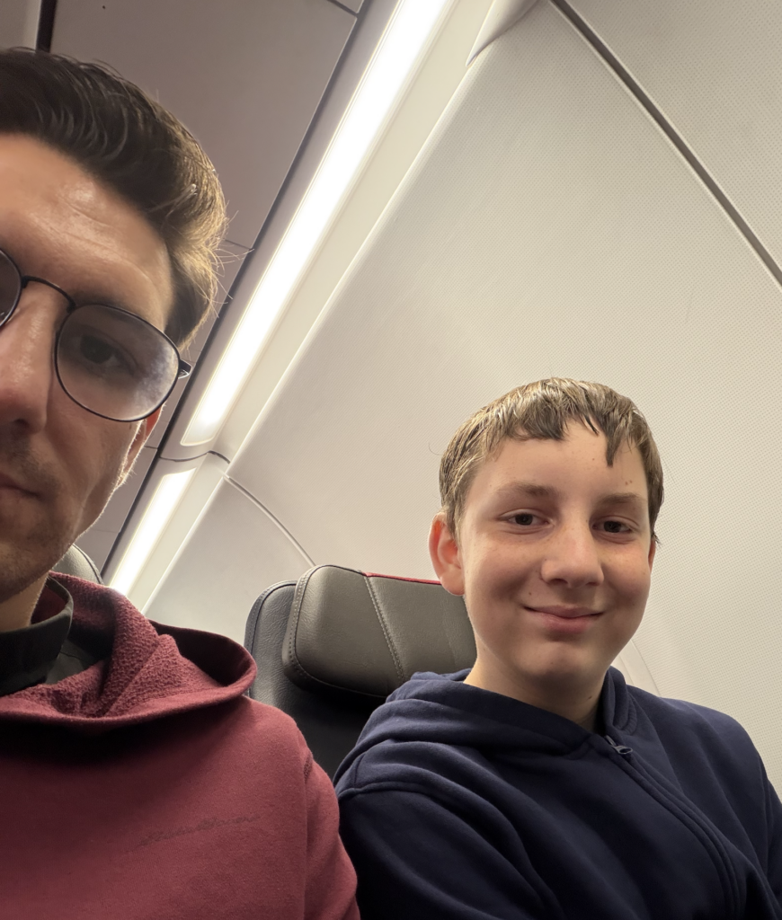 Fr. Steve Macias and his son Athanasius on their flight from SFO to Dallas for the 119th Synod of the REC Diocese of Mid-America