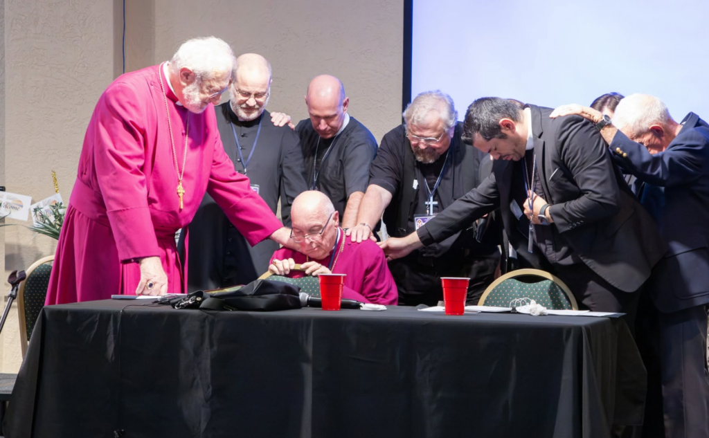 Clergy of the Reformed Episcopal Church praying over church planters during the REC100 initiative update at the 119th Synod